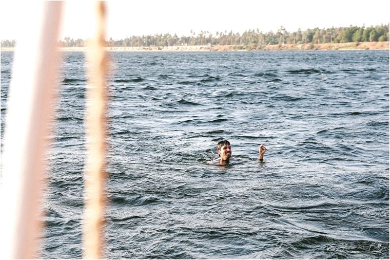 man swimming in nile river with Travel Talk Tours Felucca Odyssey 