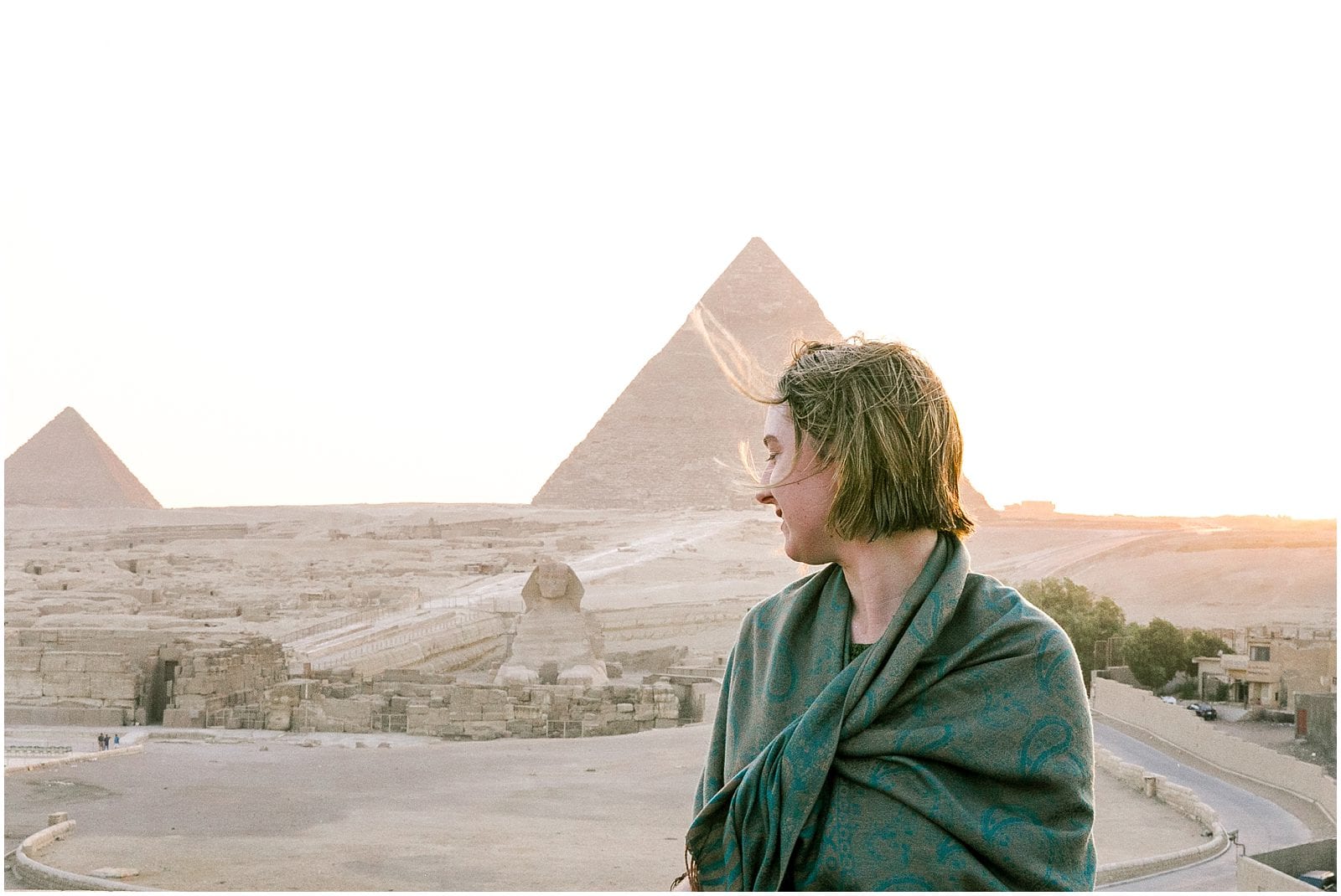 Woman in shawl at Pyramids of Giza in Cairo Egypt Sphinx