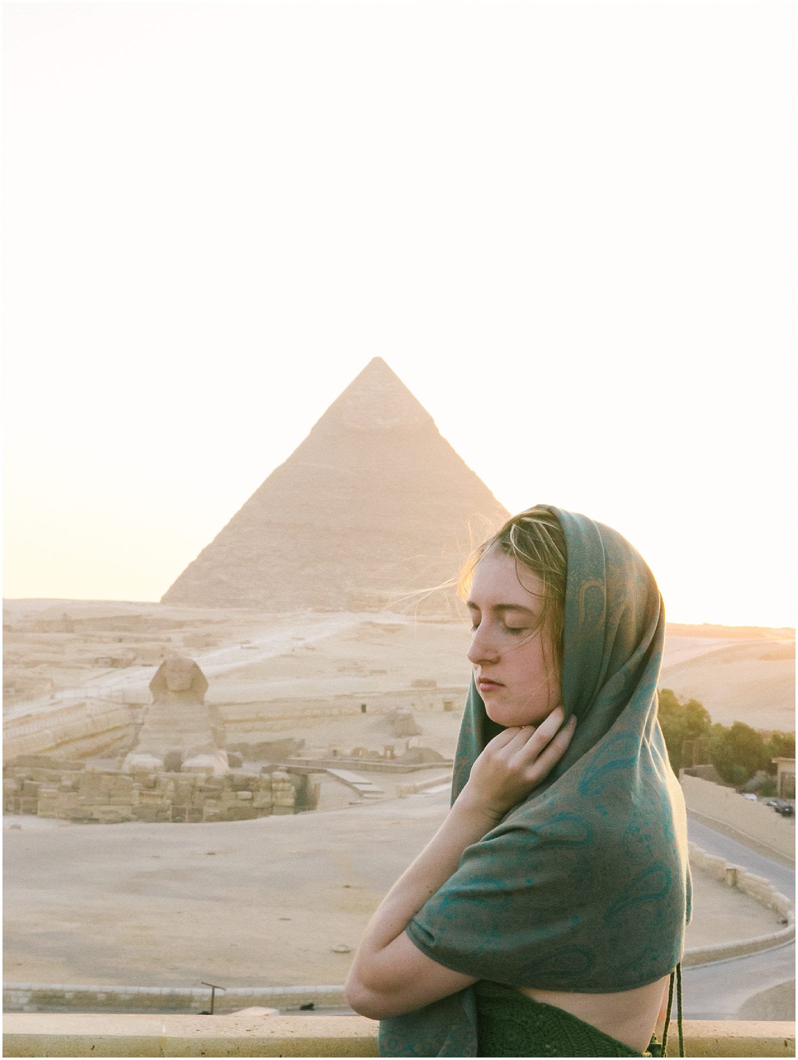 Woman in shawl at Pyramids of Giza in Cairo Egypt Sphinx