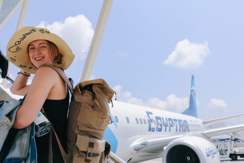 Egypt Air girl with sunhat and backpack boarding plane to Egypt