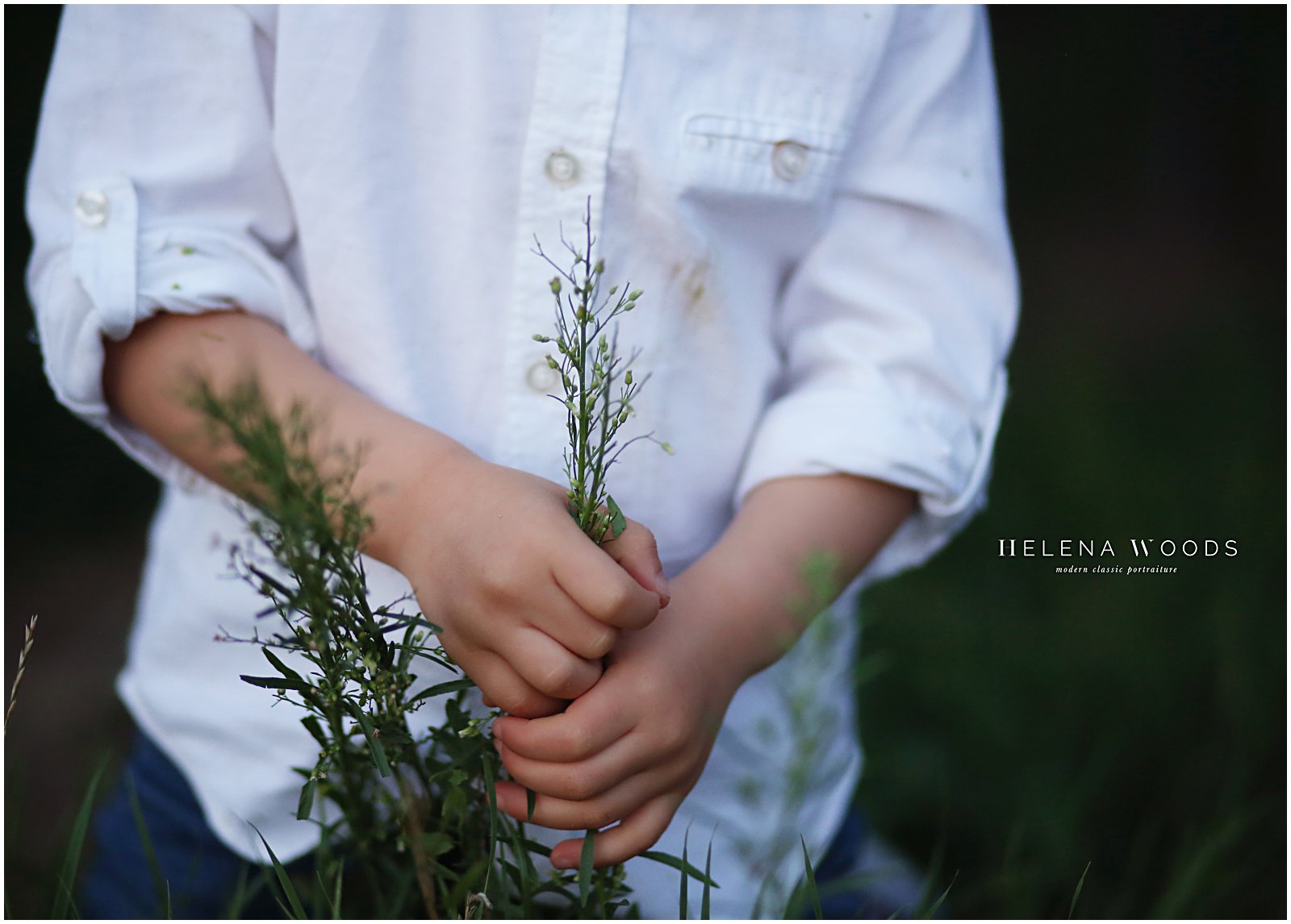 child playing with leaves and flowers photographed by children's photographer helena woods