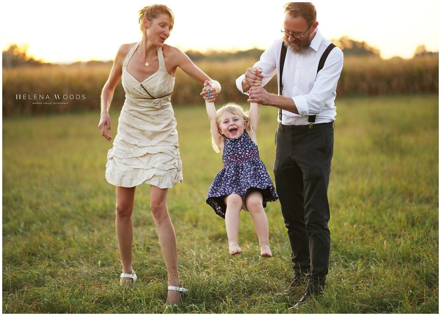 family holding toddler laughing photography by Helena Woods Photography