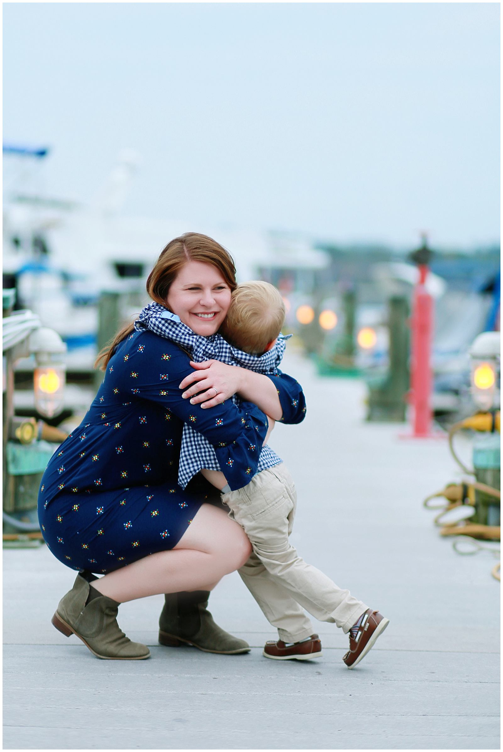 Old Town Alexandria family photographer photographs mother and son at waterfront park harbor