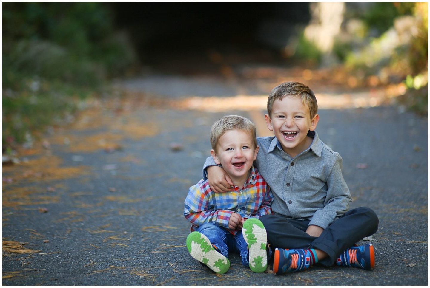 two boys laughing at Wilkes Tunnel in Old Town Alexandria VA Virginia with family photographer Helena Woods