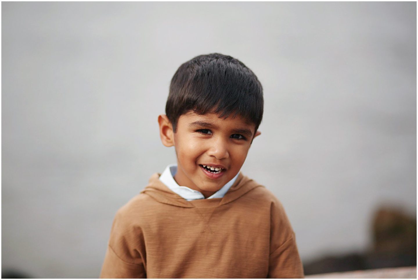 boy smiling at Gantry Park LIC by NYC family photographer