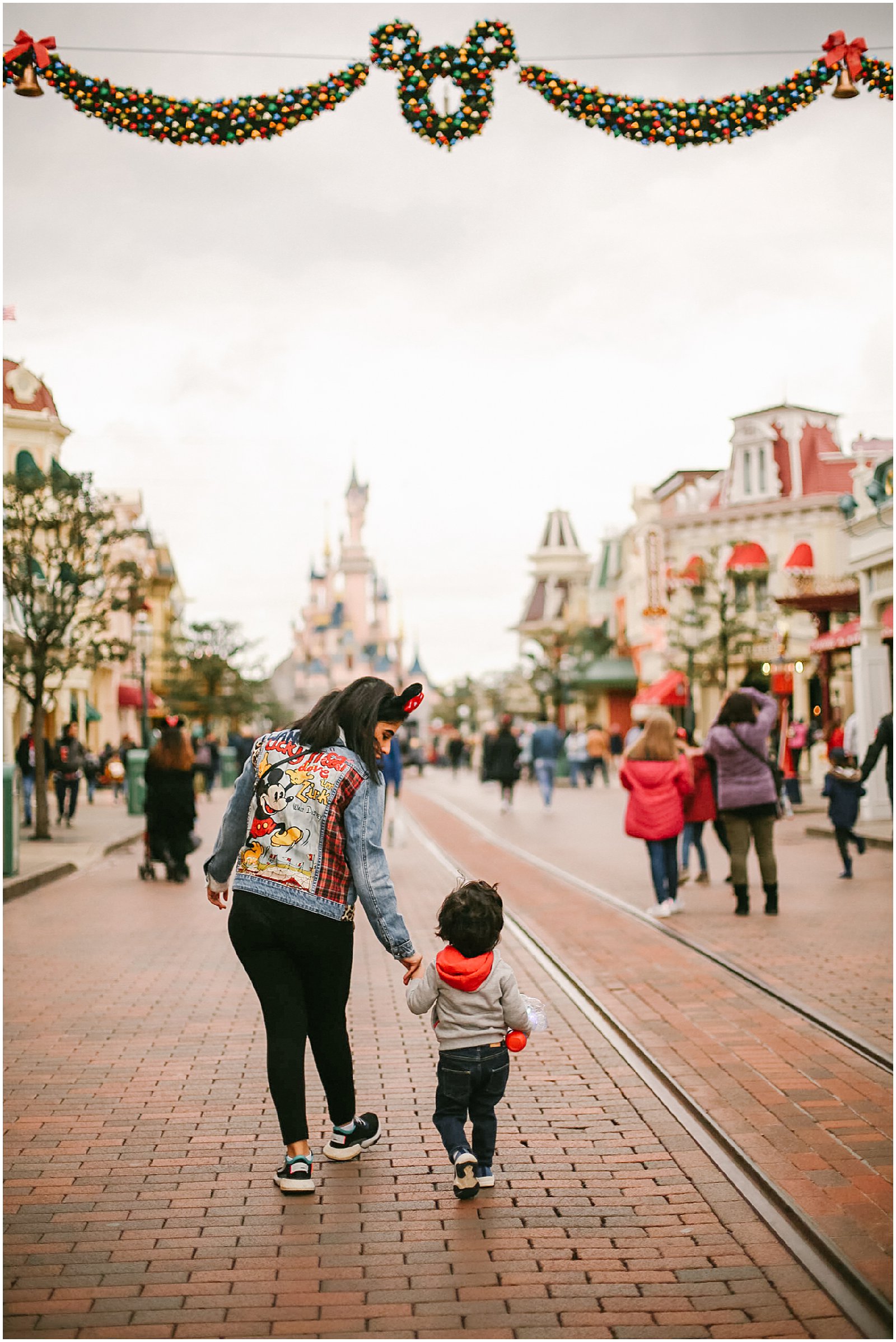 mother and son on Main Street photographed at Disneyland Paris with France photographer helena woods