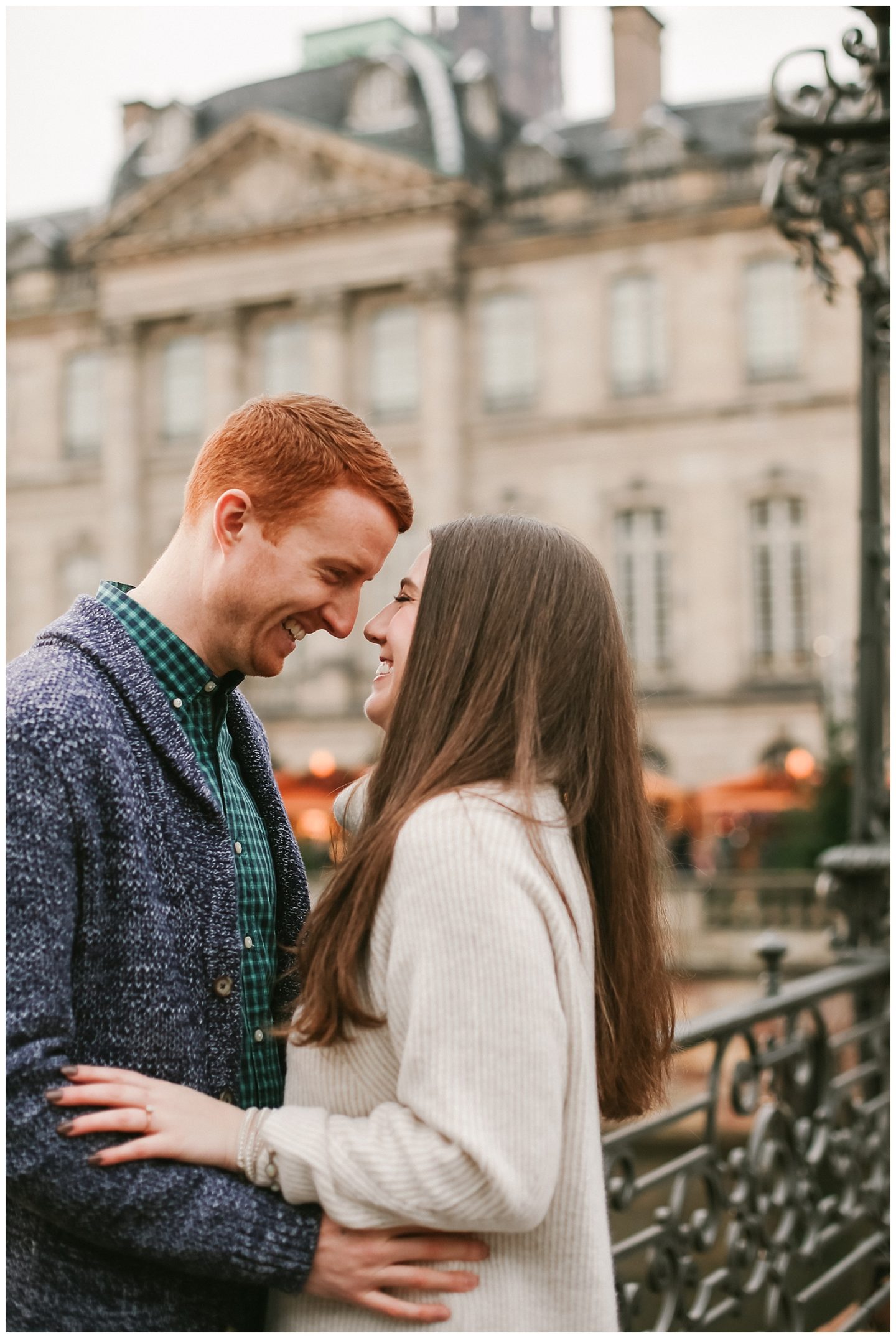 engaged couple photographed by engagement photographer in front of Palais Rohan in Strasbourg Alsace France 