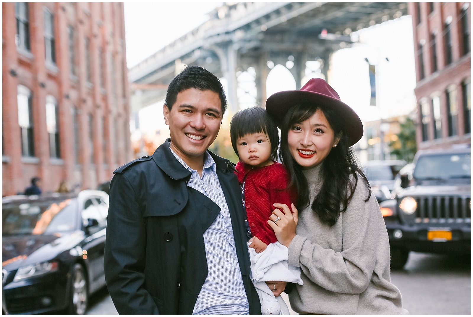 NYC family photographer photographs smiling asian family in DUMBO Brooklyn
