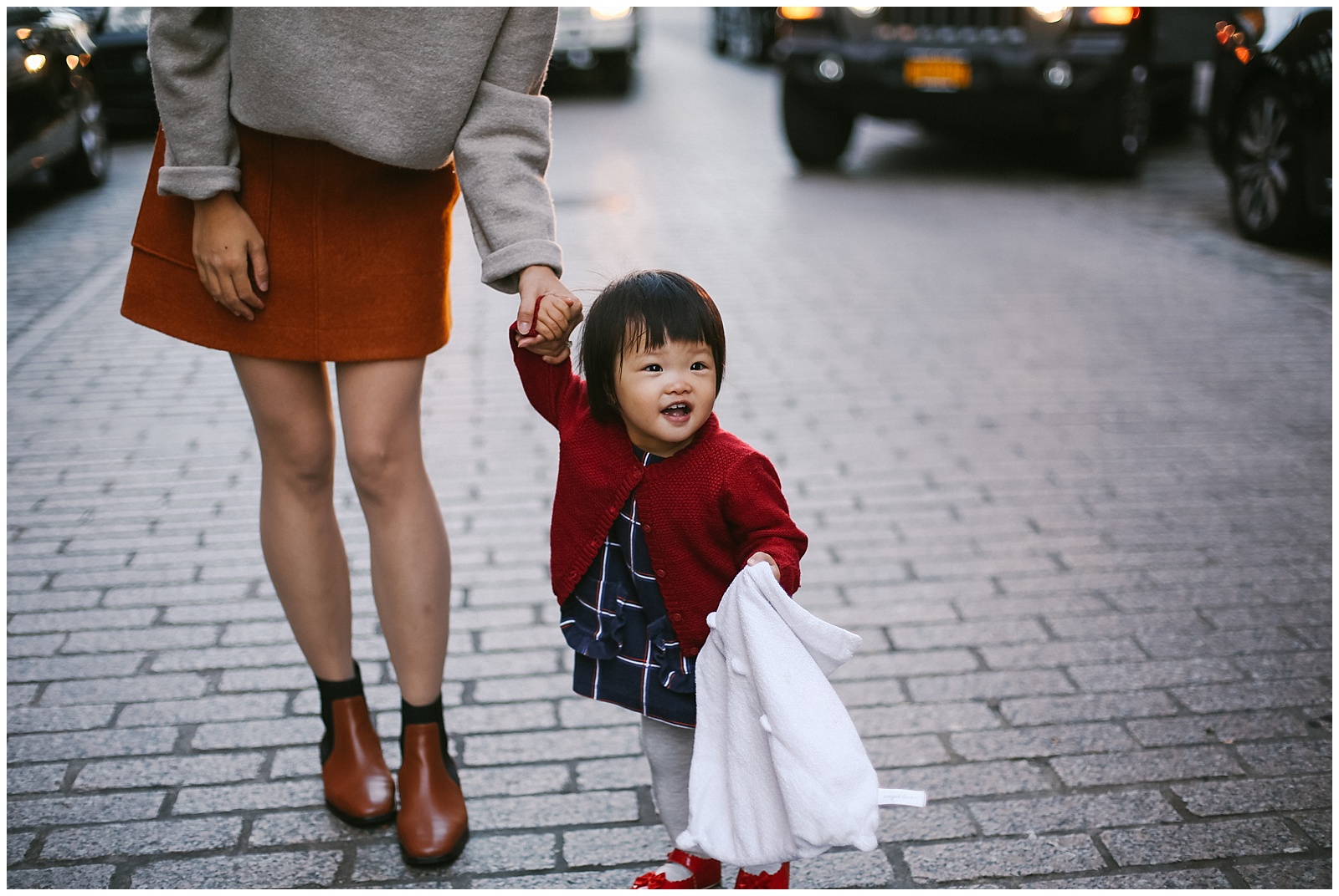 mom and baby smile for nyc family photographer in DUMBO water street