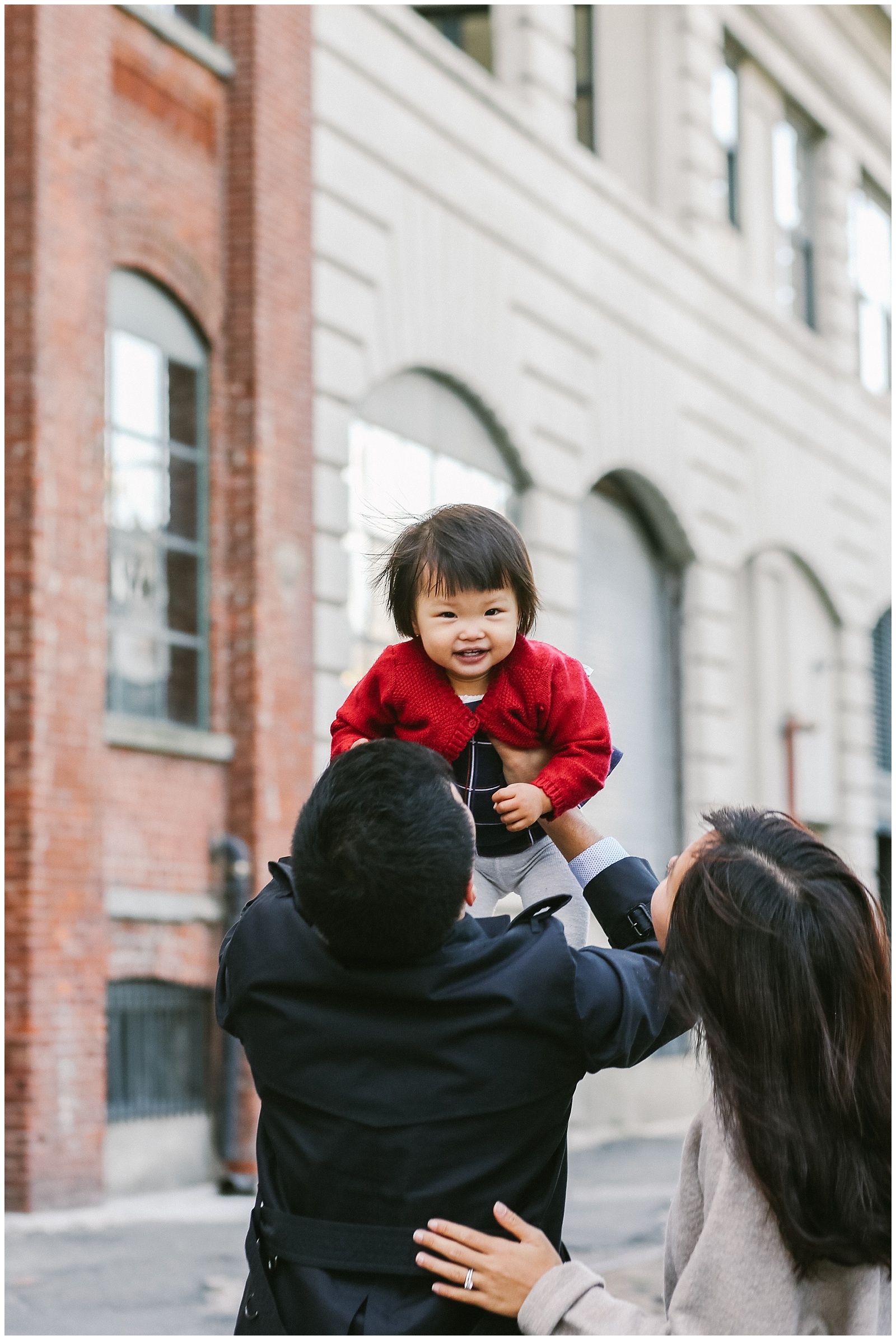 family with daughter playing in DUMBO Brooklyn for family photoshoot