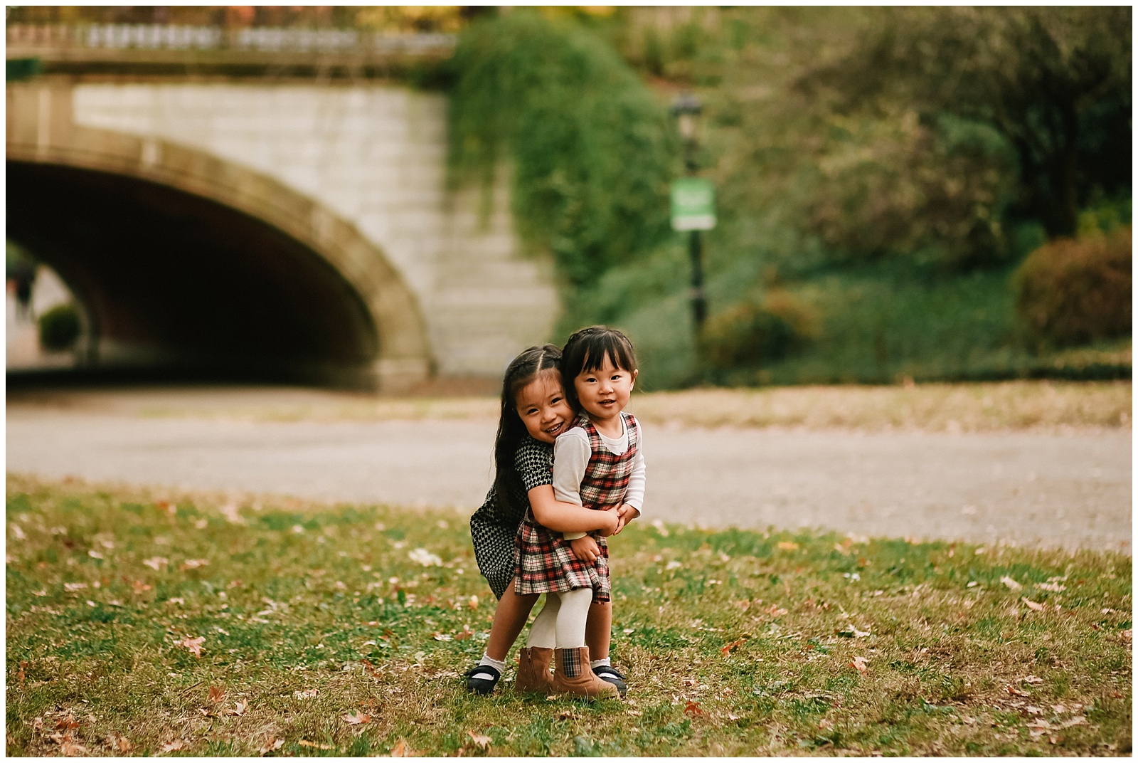 sisters hugging in central park for nyc family kids photographer Helena Woods