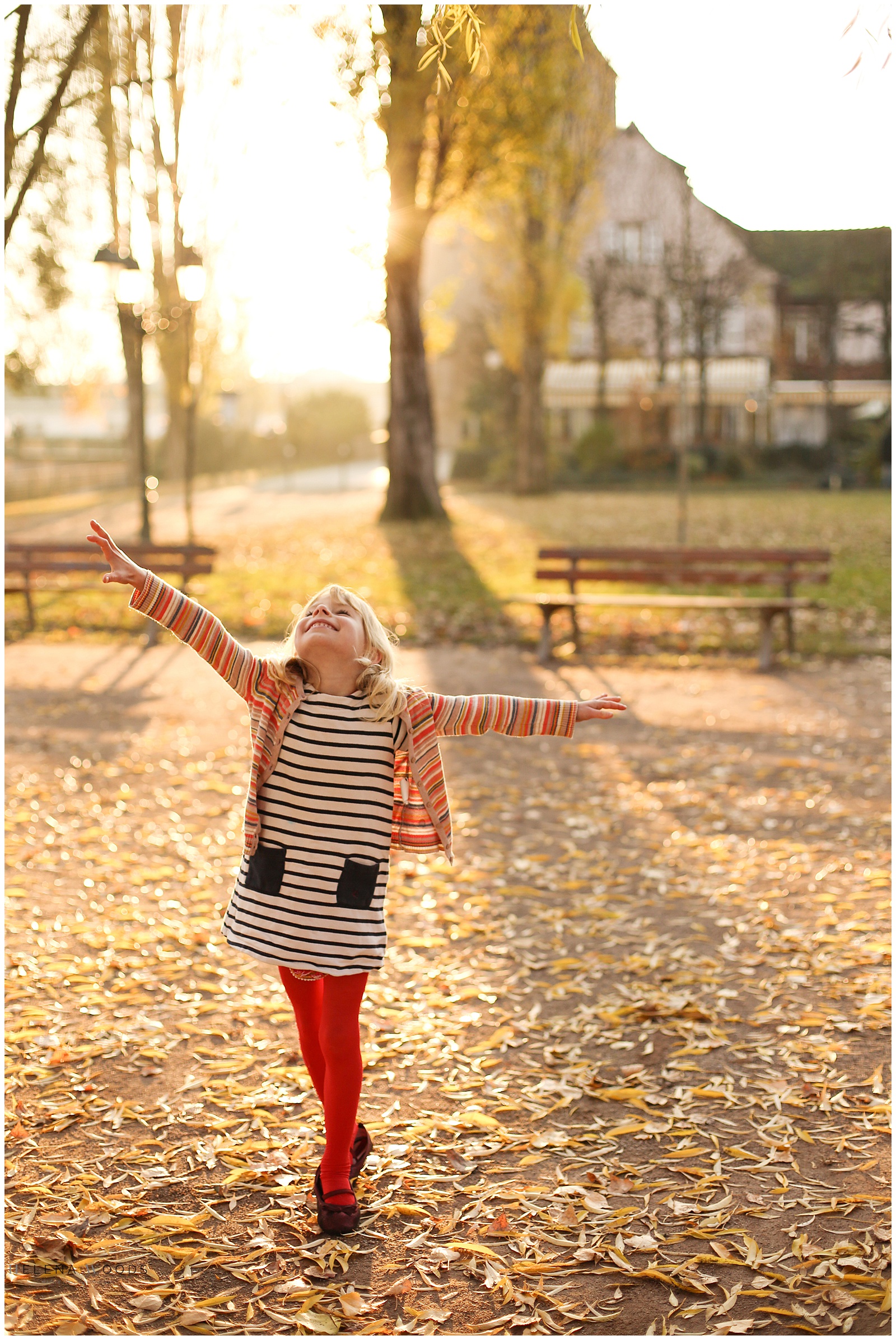 girl dancing with golden sunlight in Alsace France with children photographer Helena Woods