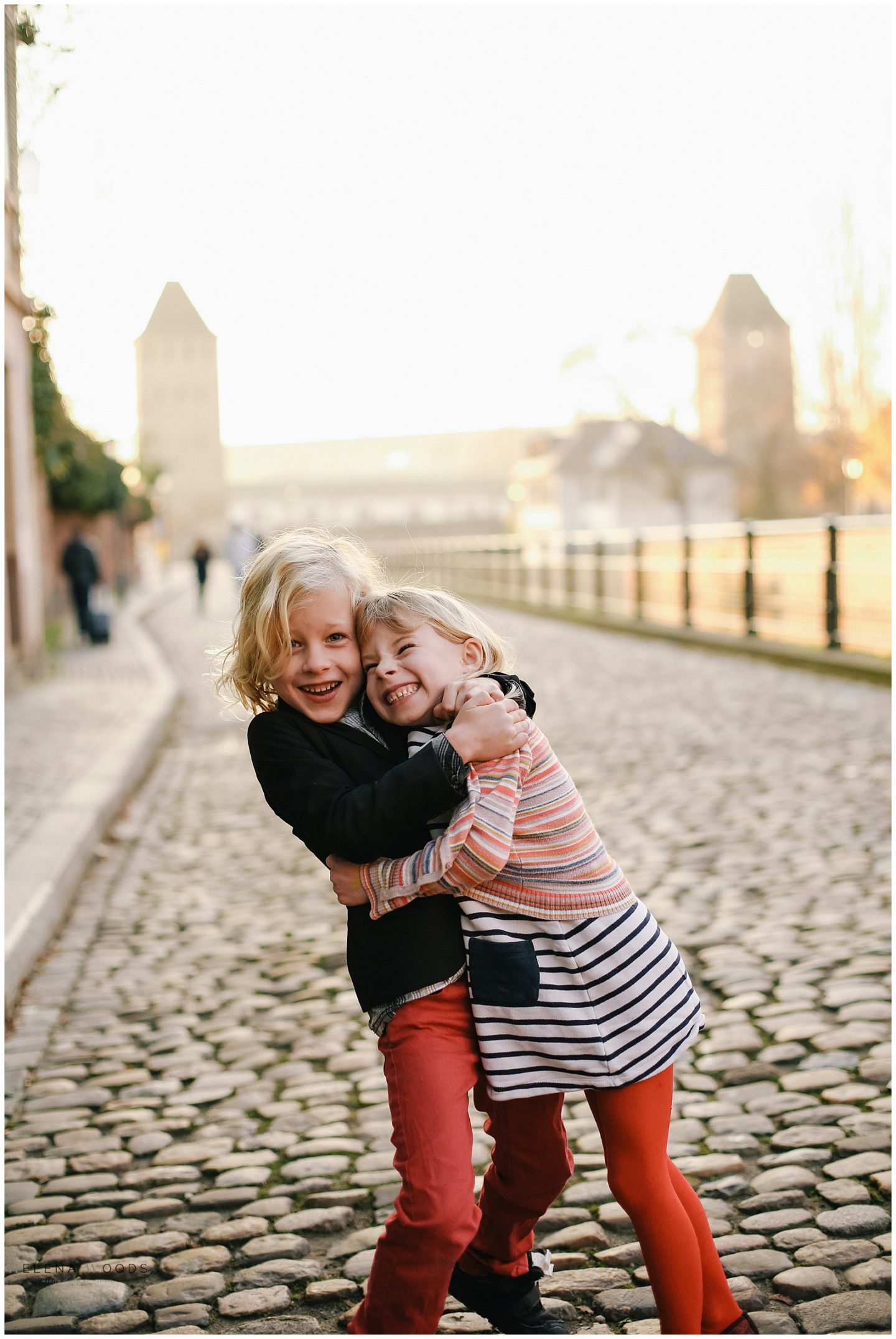 sibling kids hugging with Strasbourg France Alsace family vacation photographer | Helena Woods Photography
