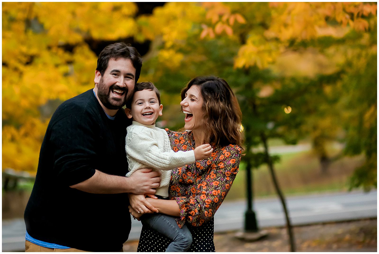 family laughing in New York City Central Park with family photographer Helena Woods